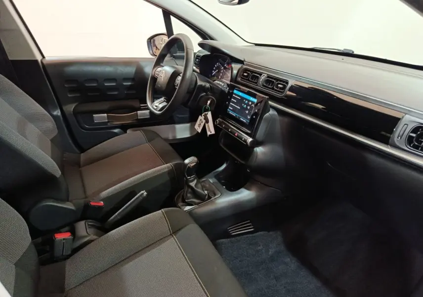 Intérieur de Citroën C3 2020 vue côté conducteur, tableau de bord noir avec écran tactile et volant multifonctions.