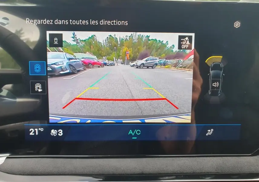 Affichage de la caméra de recul sur l’écran intérieur d’une Renault Clio VI gris Rafale, avec guidage de trajectoire coloré.