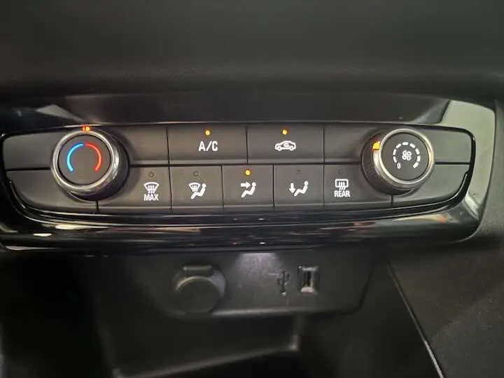 Panneau de commande de climatisation avec réglages et voyants allumés sur Opel Corsa gris métal 2021.