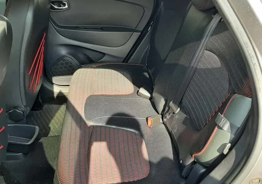 Vue intérieure côté droit des sièges arrière du Renault Captur gris Cassiopée, avec tissu noir et surpiqûres rouges.