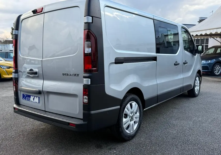 Vue 3/4 avant droite d'un Renault Trafic cabine approfondie gris Highland avec calandre noire et jantes alliage.