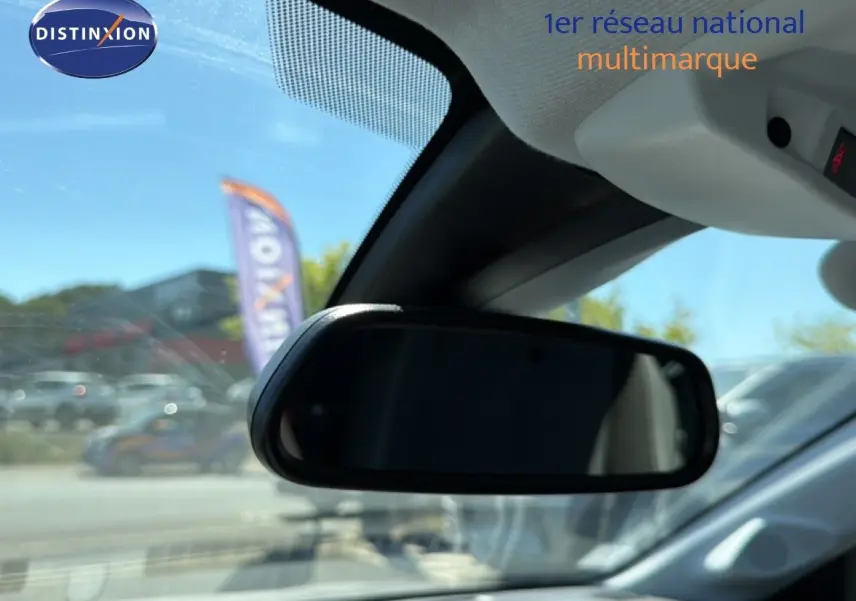 Rétroviseur intérieur noir d’une Opel Corsa gris quartz métal vue depuis l’habitacle côté conducteur par temps clair.
