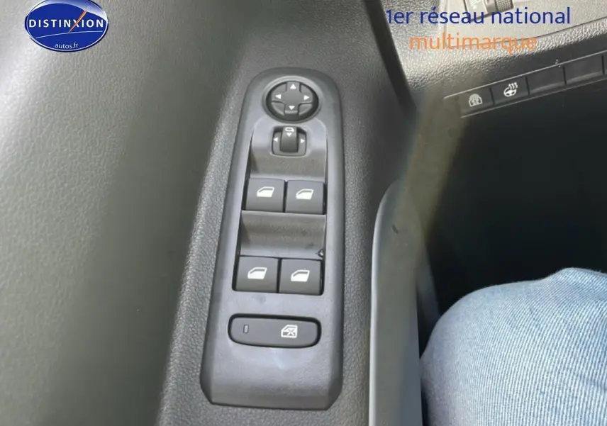 Gros plan sur les commandes des vitres électriques côté conducteur du Citroën Berlingo gris Artense 2025.