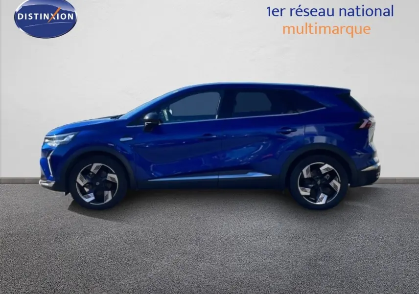 Profil droit du Renault Symbioz 2025 en bleu iron metal, SUV hybride avec jantes alliage bicolores et lignes dynamiques.