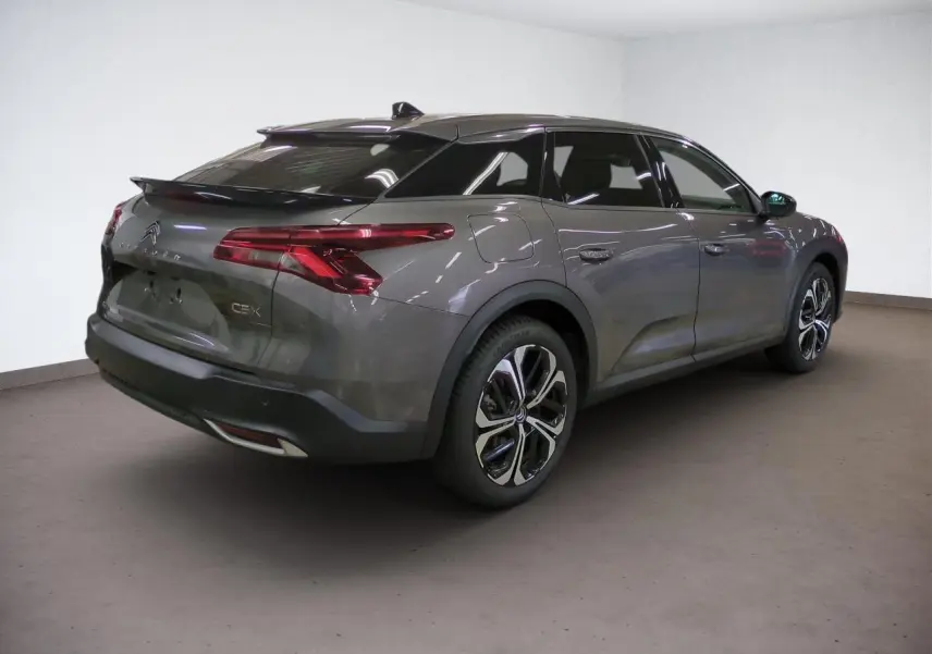 Vue 3/4 arrière droit d'une Citroën C5 X gris Platinium avec jantes alliage 19'' et feux arrière LED 3D.