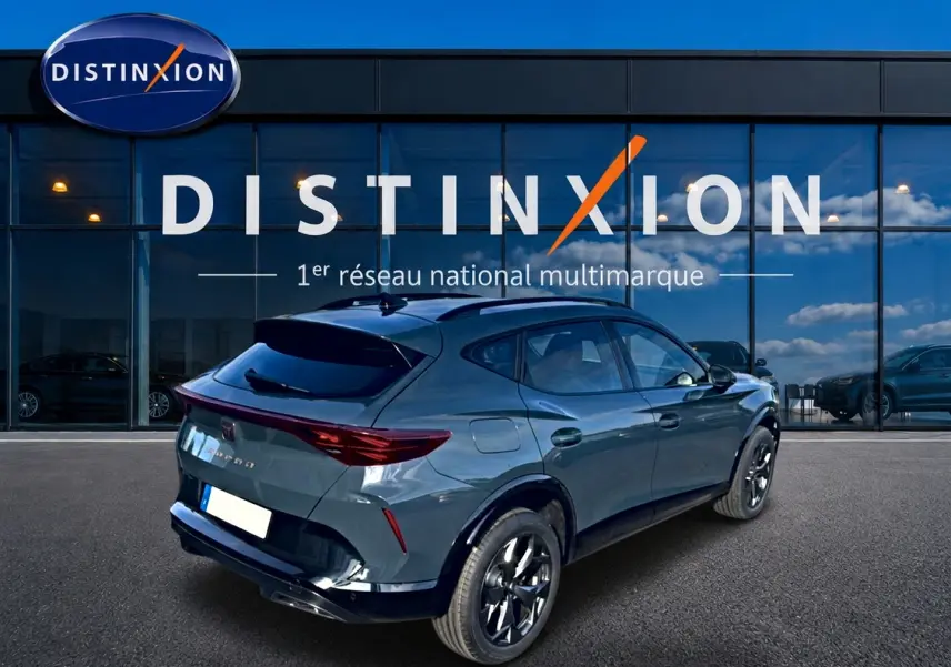 Vue 3/4 arrière droite d'un CUPRA Formentor bleu fjord avec jantes noires devant une vitrine Distinxion.