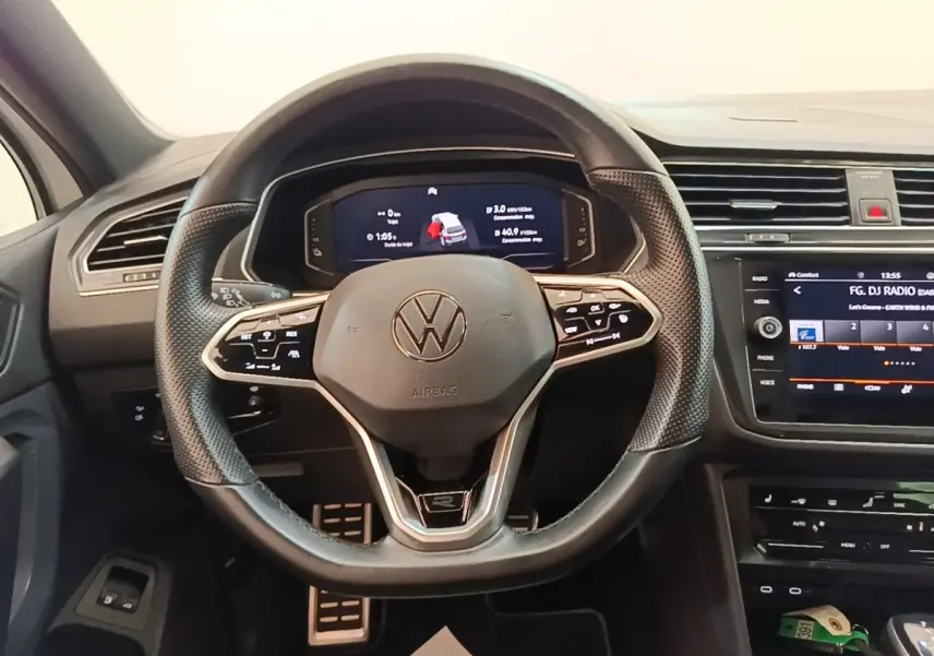 Vue intérieure centrée sur le volant cuir multifonctions et le tableau de bord digital du Volkswagen Tiguan blanc 2023.