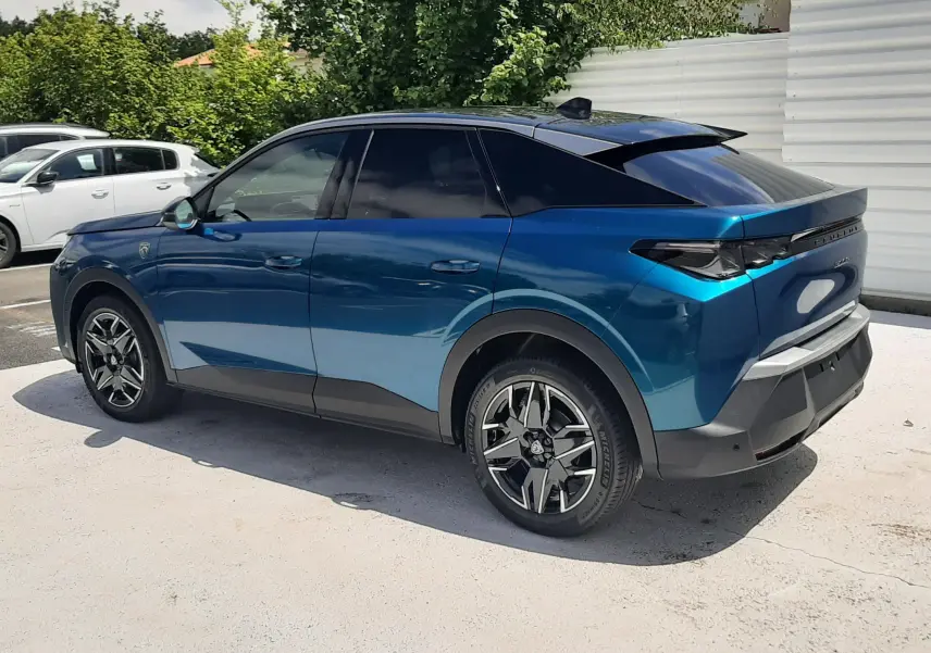 Peugeot 3008 1.2 Hybrid 145ch GT bleu obsession vue de profil côté gauche, toit noir et jantes distinctives.