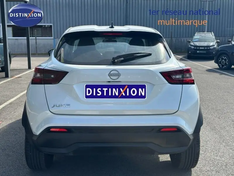 Vue arrière d'un Nissan Juke blanc nacré 2025 avec feux arrière LED et pare-chocs noir contrastant.