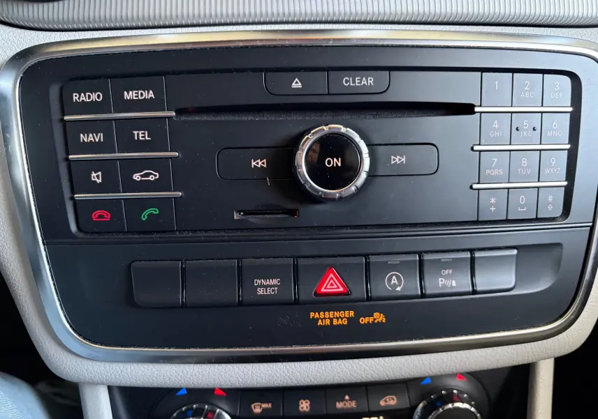 Vue rapprochée de la console centrale de la Mercedes GLA 200D Business 2015, avec commandes multimédia et climatisation.