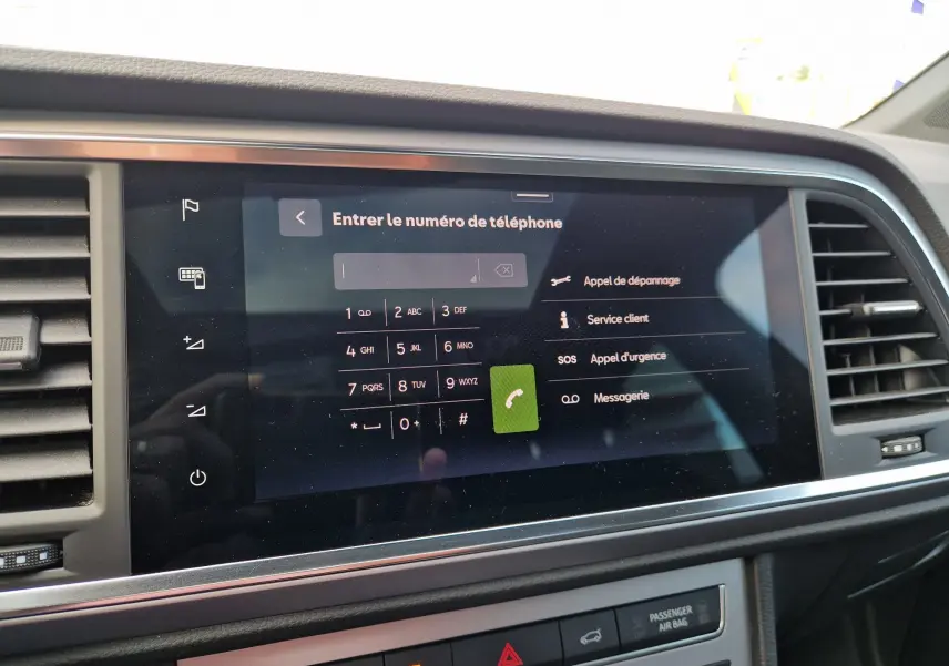 Écran tactile central du tableau de bord numérique du SEAT Ateca 2023 affichant le clavier pour entrer un numéro de téléphone.