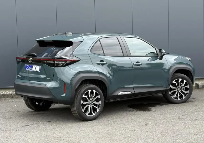 Toyota Yaris Cross 1.5 Hybrid vert impérial, vue 3/4 arrière droit avec jantes noires et toit noir.
