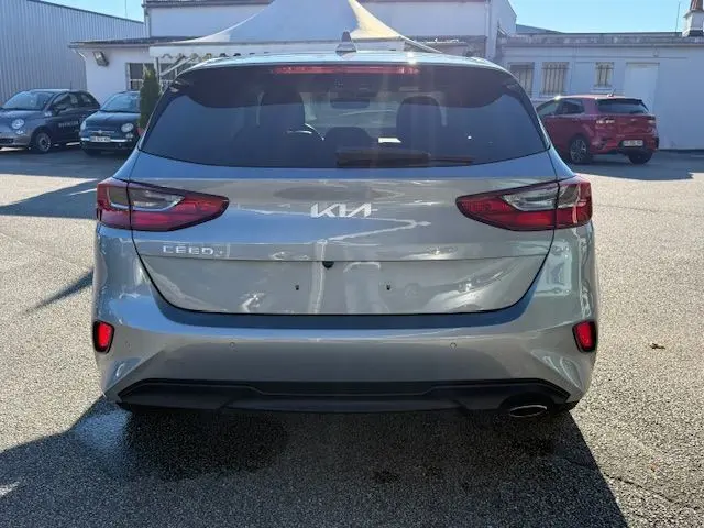 Vue arrière d'une KIA CEE'D argent lunaire 2024, avec feux LED et logo moderne bien visibles.