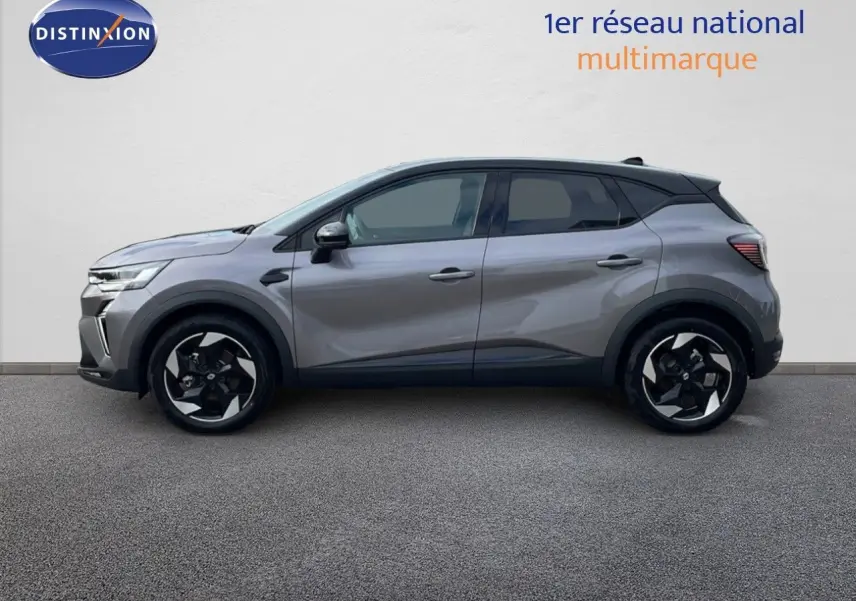 Profil côté gauche du Renault Captur E-Tech F.Hybrid 2025 gris Cassiopée métal avec toit noir et jantes bicolores.