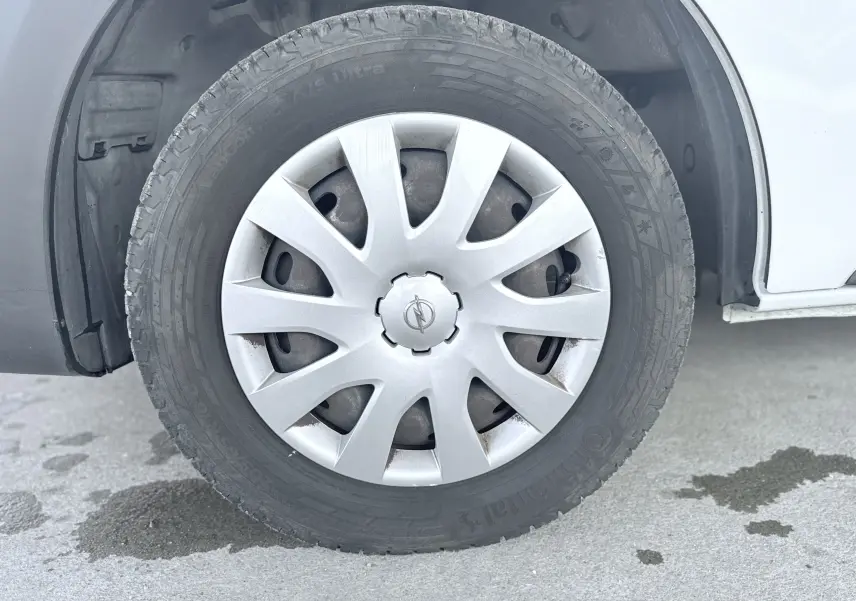 Gros plan sur la roue avant gauche blanche d’un Opel Vivaro 2018 avec enjoliveur argenté et pneu Continental.