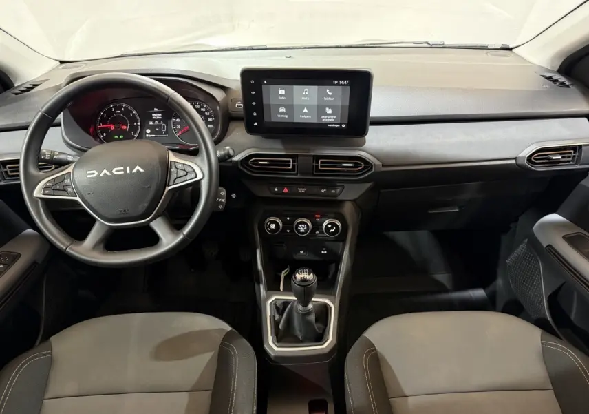 Vue intérieure avant du tableau de bord et volant noir de la Dacia Sandero Extreme+ TCe 110 avec écran tactile central.