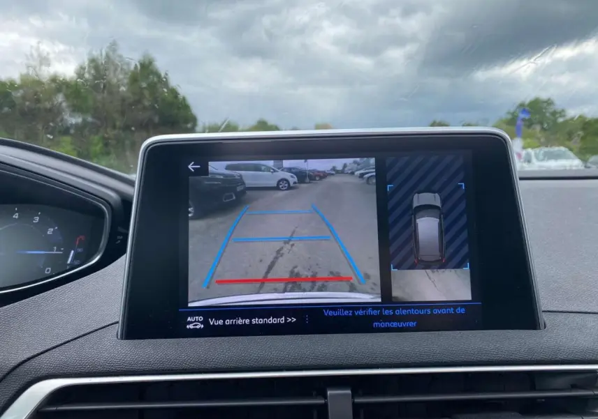 Écran tactile intérieur du Peugeot 3008 blanc 2019 montrant la caméra de recul avec aide au stationnement.