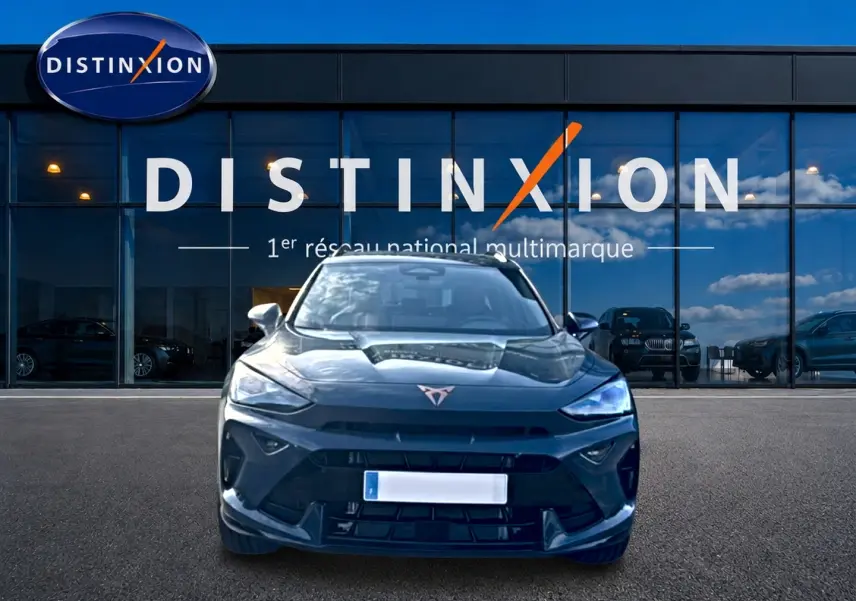 Vue frontale d'un CUPRA Formentor bleu fjord 2026, avec calandre marquée et logo distinctif sur fond de vitrine Distinxion.