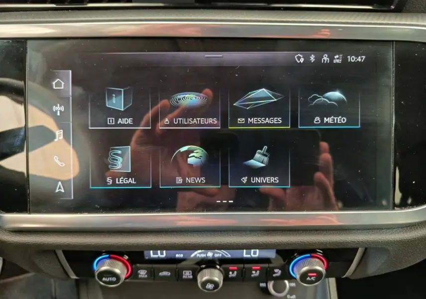 Écran tactile central de l'Audi Q3 Sportback 35 TDI 150 Business Line, affichage des menus, intérieur noir.