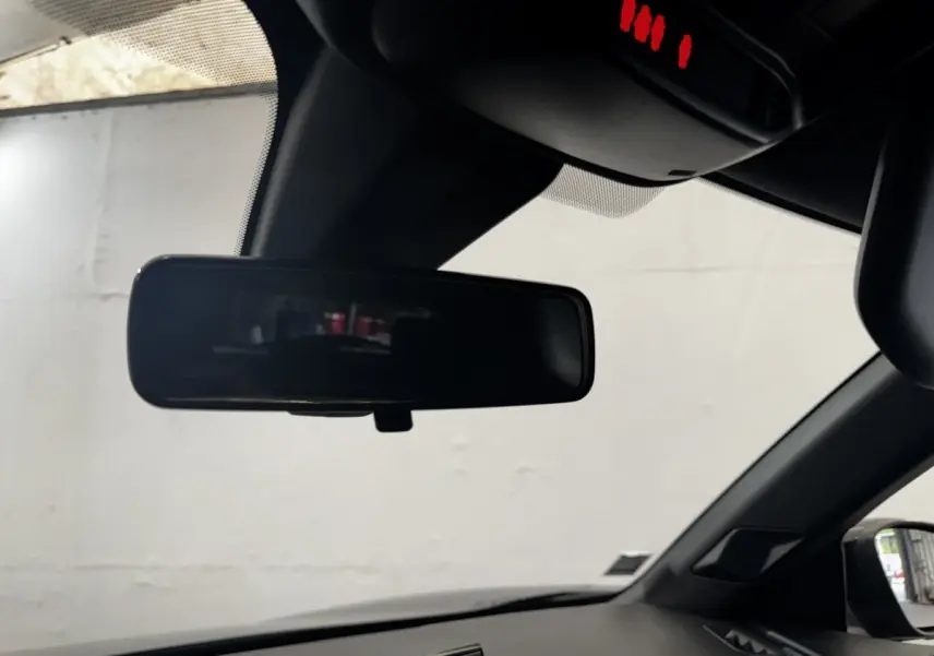 Vue intérieure du rétroviseur central et partie supérieure du pare-brise d'une DS3 Crossback gris foncé, avec capteur de pluie visible.