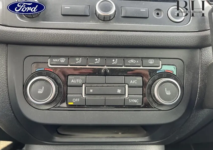 Vue avant rapprochée du tableau de bord noir du Volkswagen Tiguan gris poivre, mettant en valeur la climatisation automatique bi-zone.