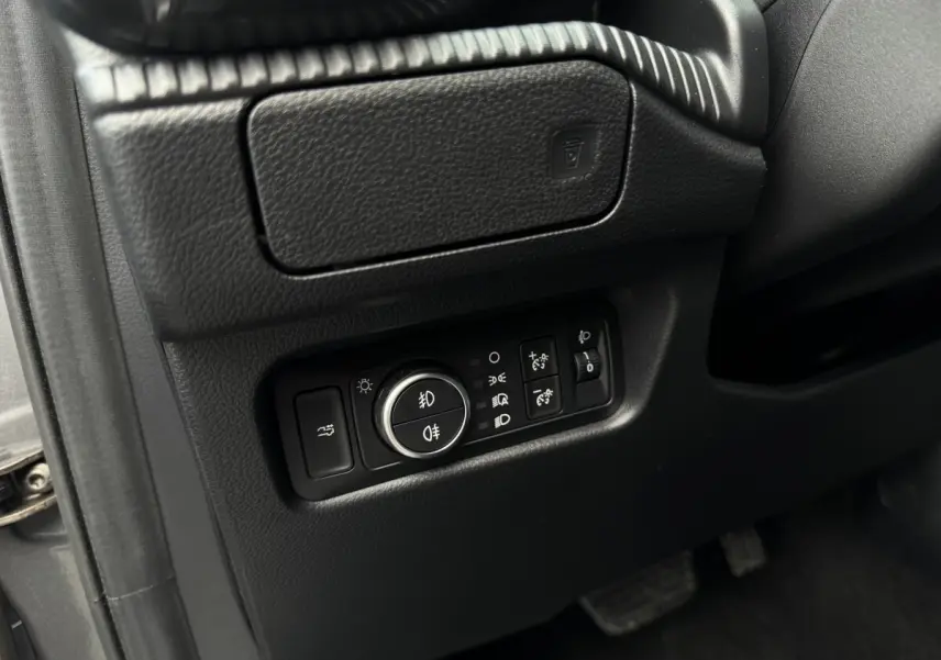 Gros plan sur les commandes d’éclairage noires à gauche du volant dans l’habitacle du Ford Ranger 2025.