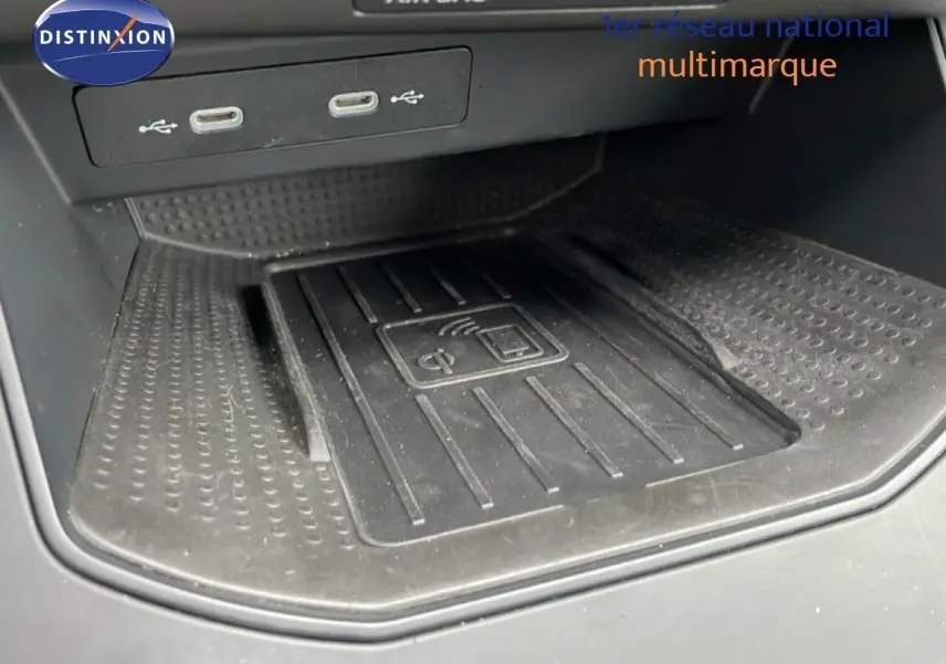 Gros plan sur le chargeur sans fil et ports USB-C dans l'habitacle du SEAT Arona 2025.