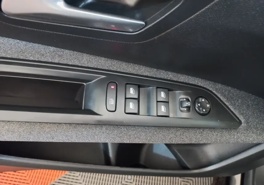 Commande des vitres électriques et réglage des rétroviseurs sur la porte côté gauche d’un Peugeot 3008 noir 2022.