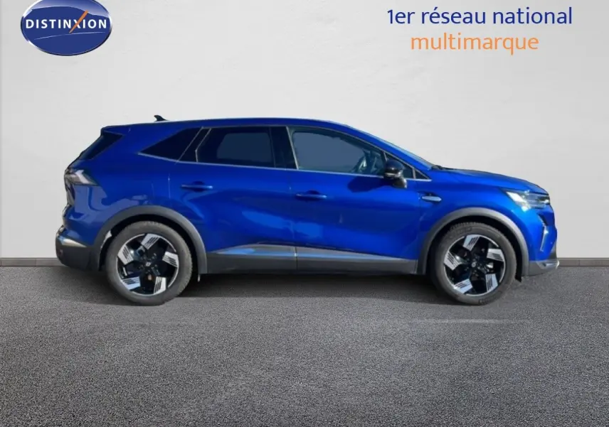 Profil droit du Renault Symbioz 2025 bleu iron metal, SUV hybride avec jantes bicolores et lignes dynamiques.