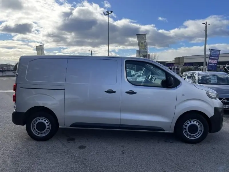 Vue de profil côté gauche d’un Peugeot Expert Fourgon gris métal 2018, avec portes coulissantes et roues acier simples.