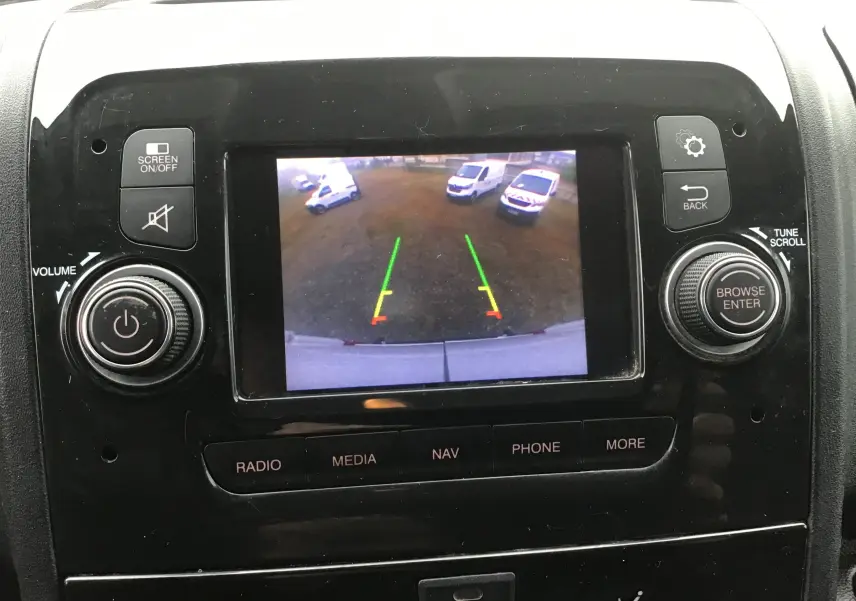 Vue rapprochée de l’écran central du Fiat Ducato blanc 2021 montrant la caméra de recul avec lignes de guidage colorées.