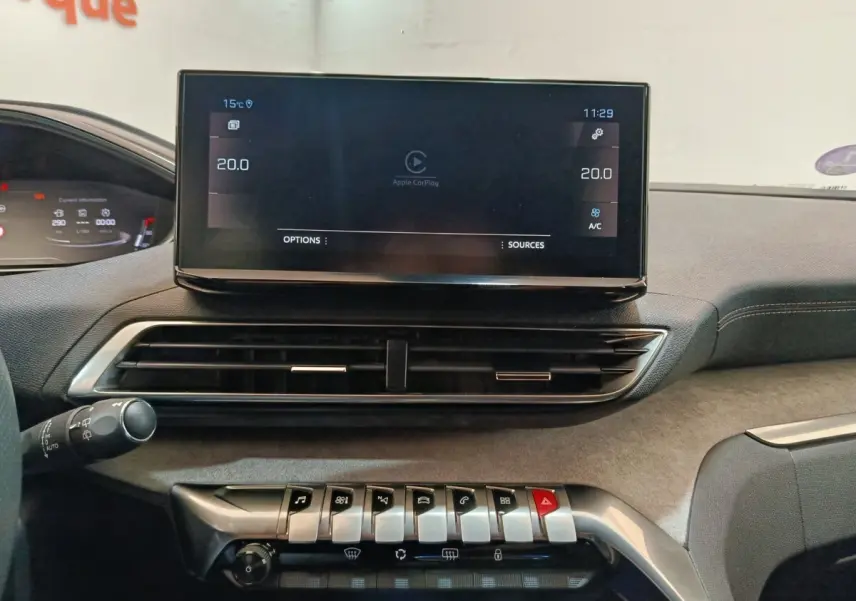 Vue rapprochée de la console centrale du Peugeot 5008 GT 2023, écran tactile et commandes piano visibles.