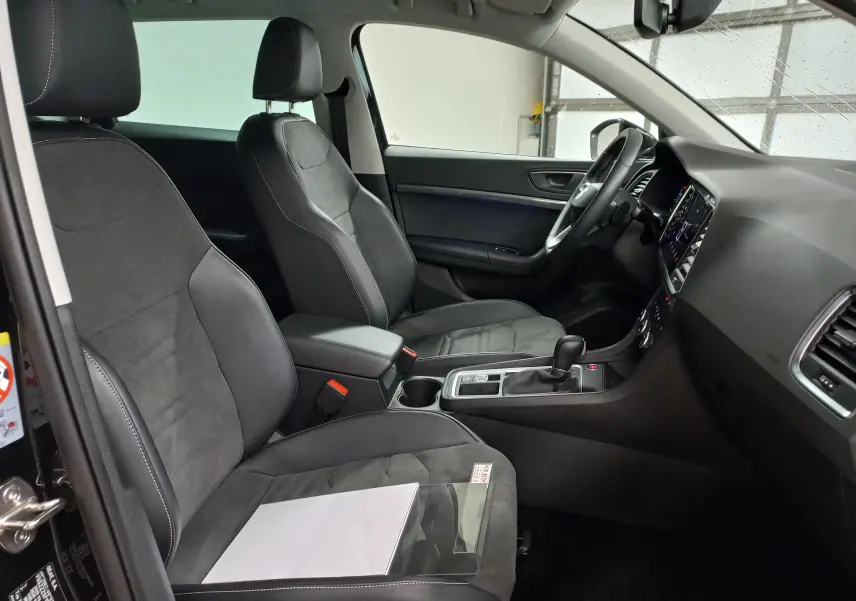 Intérieur avant droit du SEAT Ateca 2.0 TDI 150 DSG7 Copa avec sièges noirs en cuir et alcantara, tableau de bord moderne.