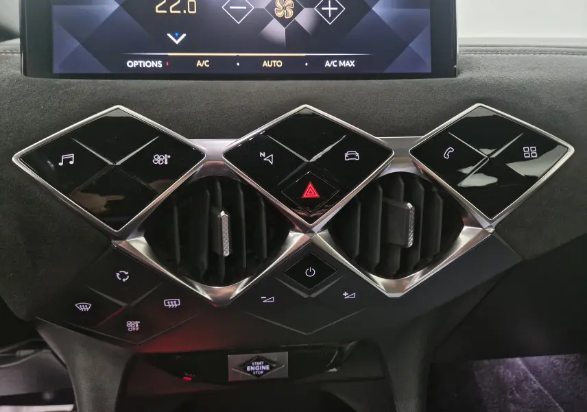 Vue rapprochée du tableau de bord noir du DS3 Crossback 2019, mettant en valeur les commandes tactiles et les aérateurs géométriques.