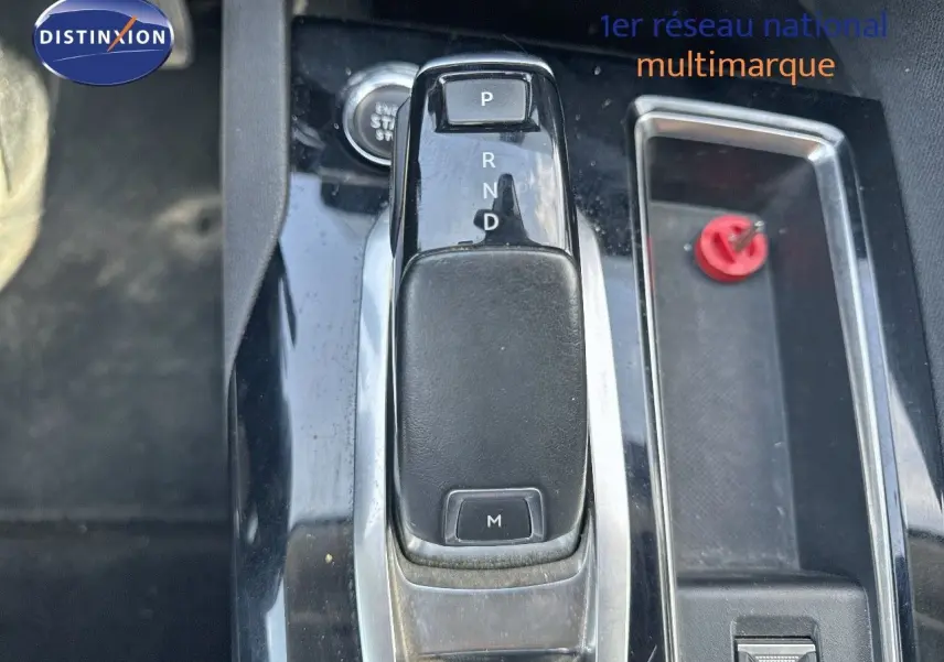 Gros plan sur la console centrale du Peugeot 3008 avec levier de vitesse automatique noir brillant et bouton de démarrage.