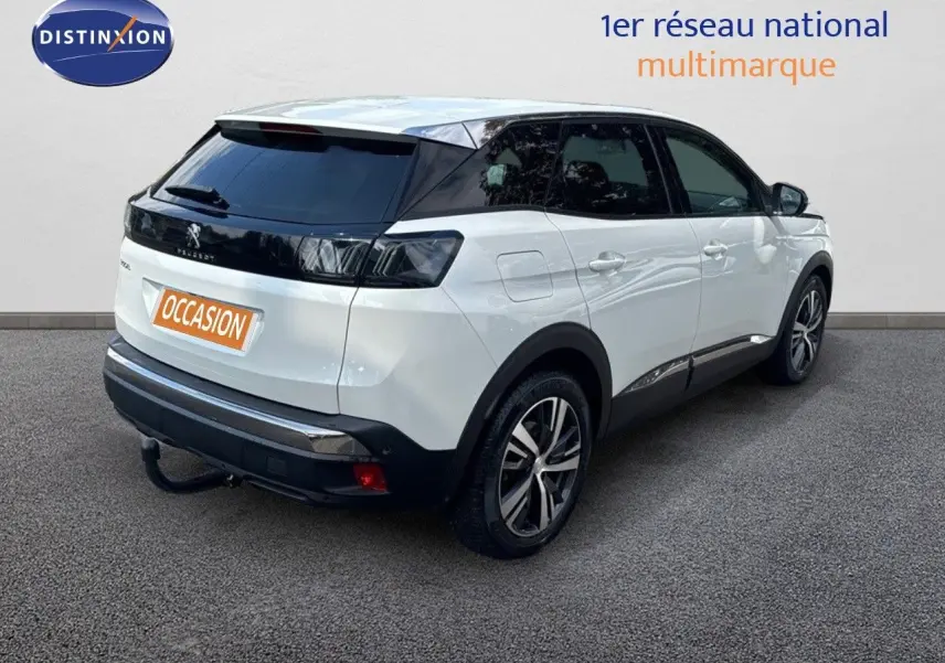 Vue 3/4 arrière droite d’un Peugeot 3008 blanc nacré avec toit noir et jantes alliage bicolores.