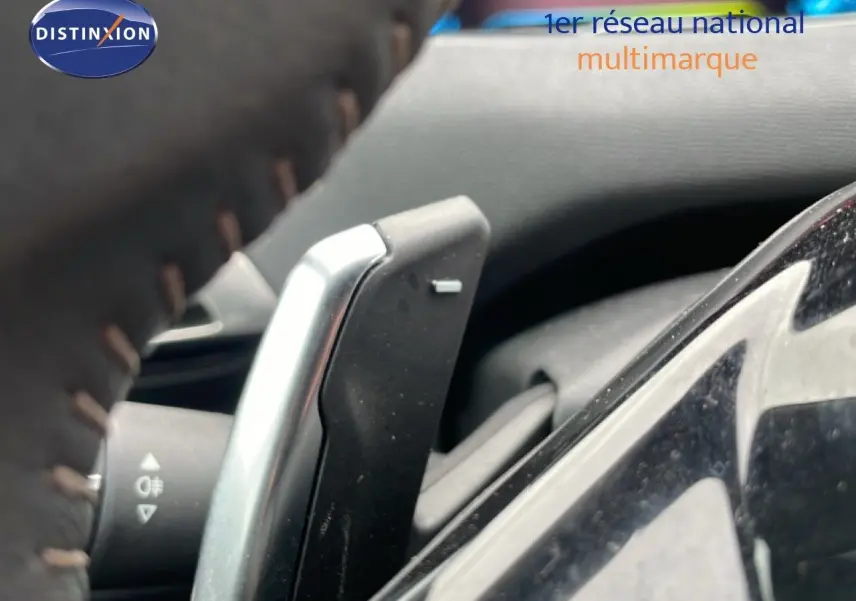 Gros plan sur la palette de changement de vitesse côté droit du volant d’un Peugeot 3008 gris Artense 2024.