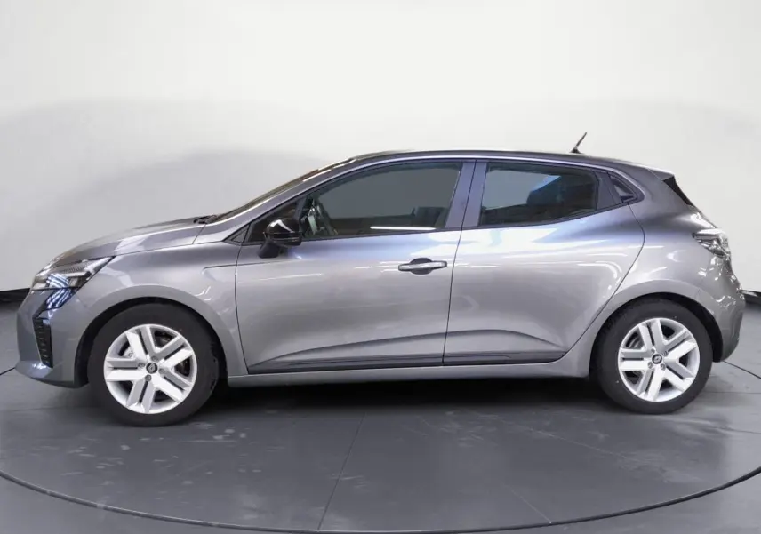 Profil droit de la Renault Clio V E-Tech Full Hybrid gris schiste avec jantes alliage et lignes fluides visibles.