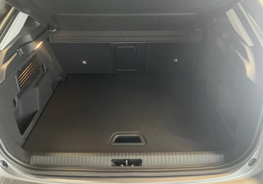 Coffre ouvert de la Citroën C4 gris, vue de l'arrière montrant un espace de chargement propre et bien fini.