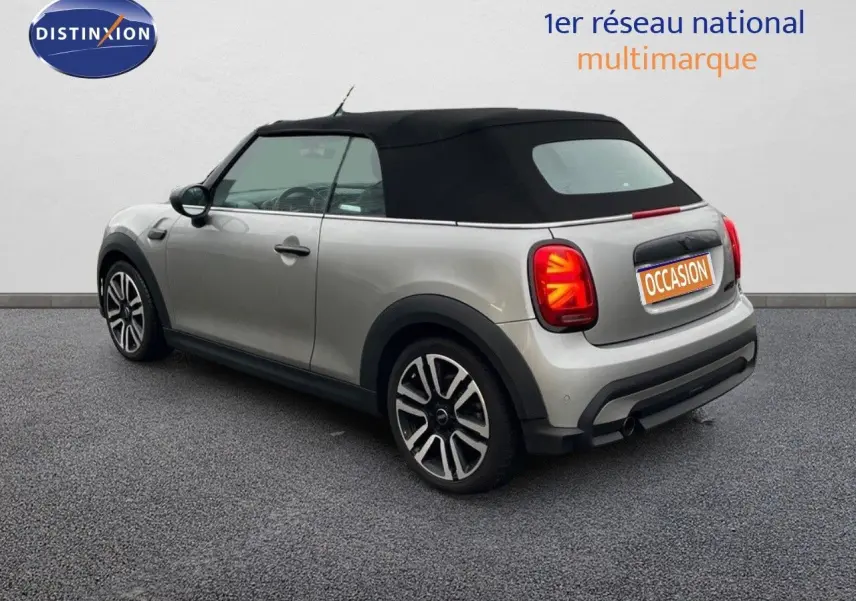 Vue 3/4 arrière droite d'une MINI Cabriolet 2023 couleur Melting Silver Metal avec capote noire fermée.