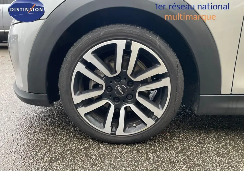 Gros plan sur la roue avant gauche avec jante bi-ton gris et noir d'une MINI Cabriolet Melting Silver 2023.