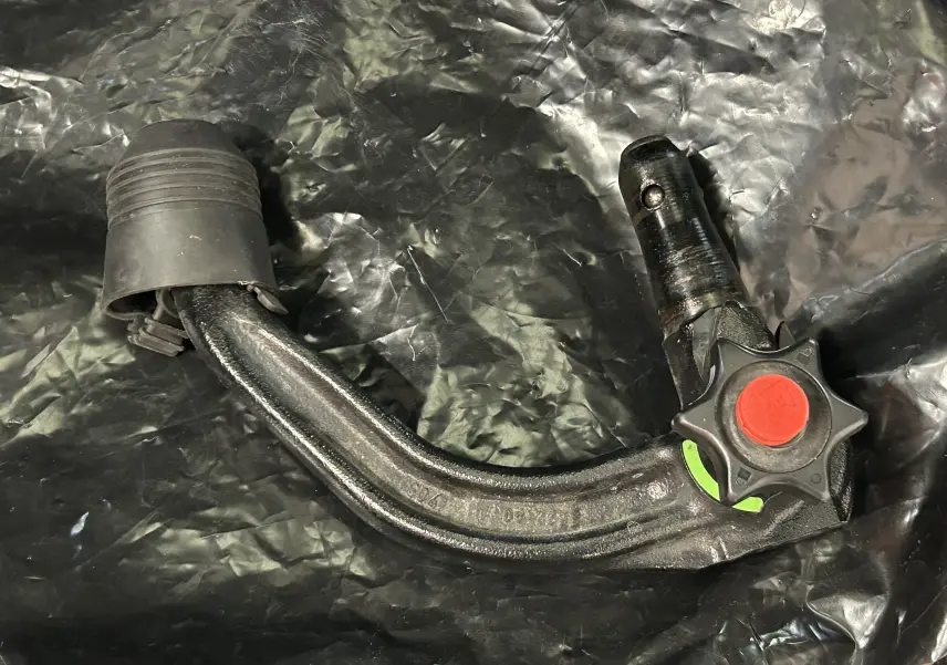Gros plan sur un attelage de remorque noir compatible Audi A6 Avant 40 TDI, avec molette de verrouillage rouge et verte.
