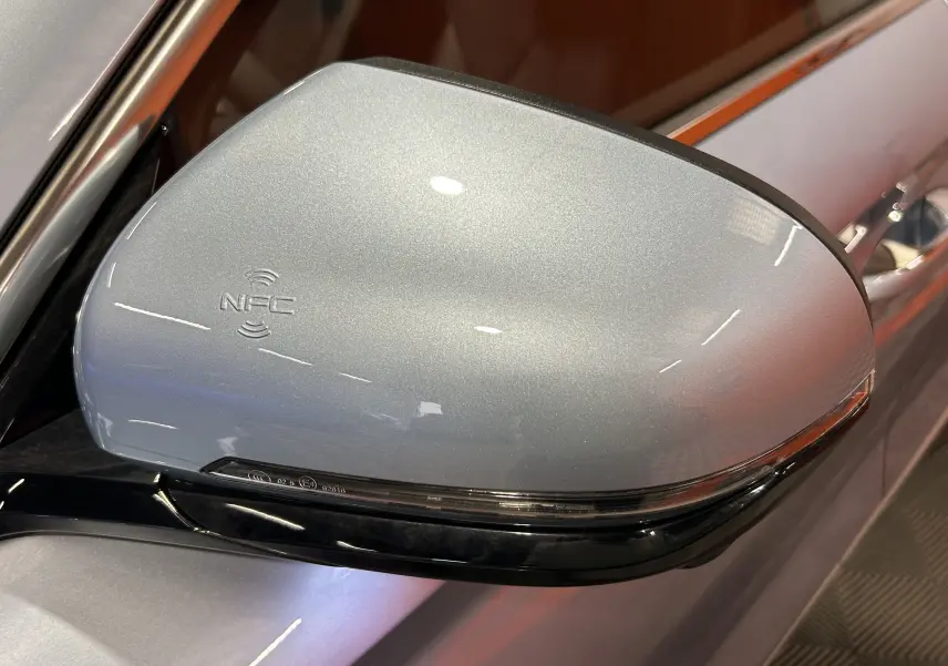 Rétroviseur côté droit gris métallisé avec logo NFC sur une BYD SEAL U hybride rechargeable 2025.