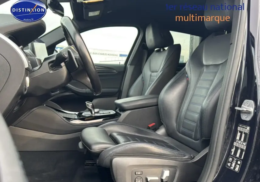 Vue intérieure côté conducteur du BMW X4 noir (g02) xdrive30d 286 m sport, mettant en valeur les sièges sport en cuir et la console centrale.