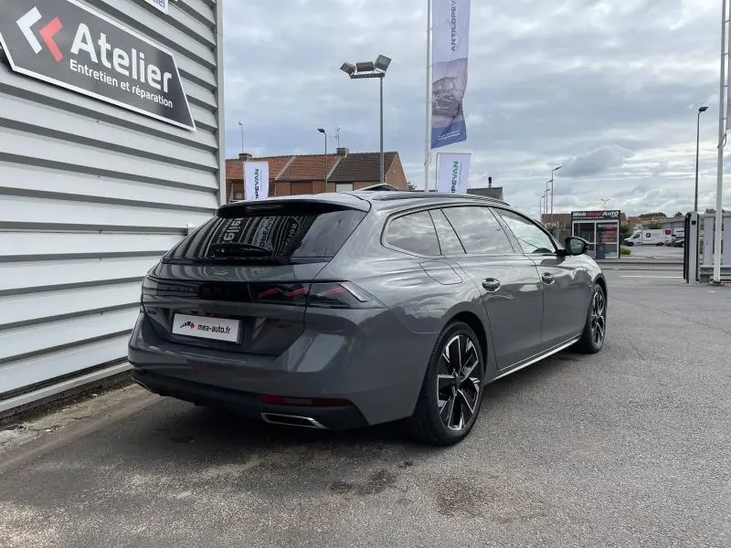 Peugeot 508 SW Gris Selenium vue 3/4 arrière droit, avec jantes alliage noires et vitres arrière surteintées.