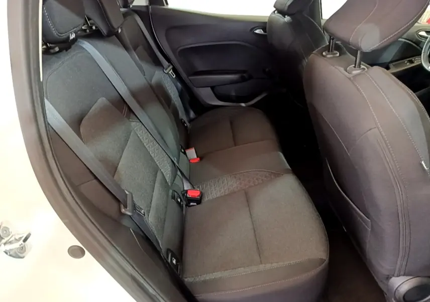 Vue intérieure côté gauche montrant la banquette arrière noire et les sièges avant du Renault Clio Business blanc.