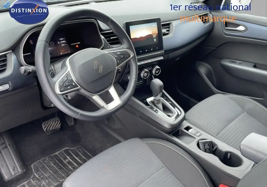 Vue intérieure côté conducteur du Renault Arkana 2025, avec tableau de bord moderne et sellerie tissu gris.