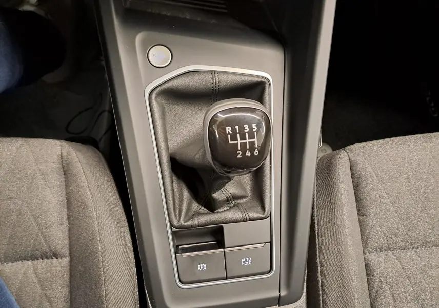 Le levier de vitesses manuel 6 rapports de la Volkswagen Golf 1.5 TSI 116 BVM6, entouré de sièges en tissu gris.