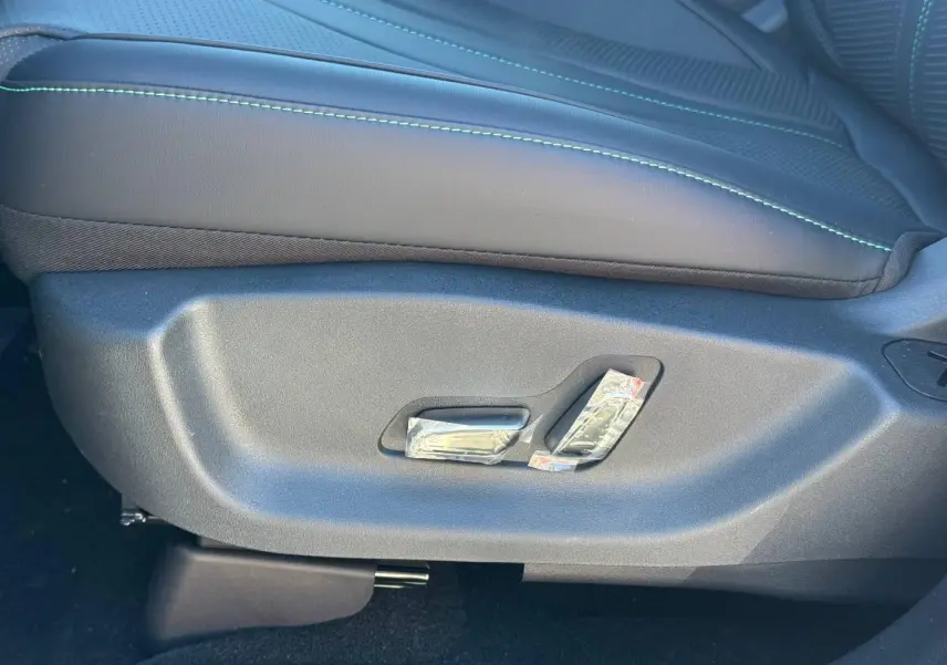 Détail du côté gauche du siège avant noir avec surpiqûres vertes du BYD SEAL U hybride rechargeable 2026.