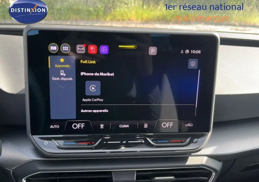 Écran tactile central du tableau de bord du SEAT Leon blanc neige, affichant Apple CarPlay et commandes climatisation.